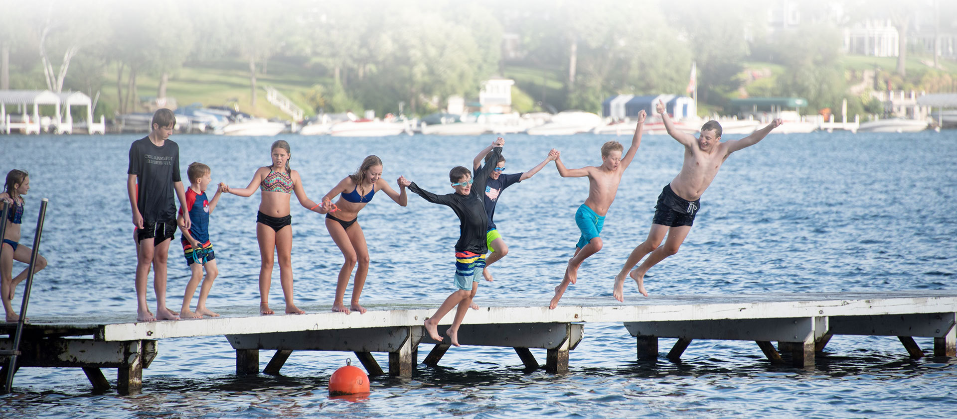 kids jumping off dock